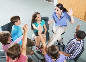 teacher with student in a blended learning classroom