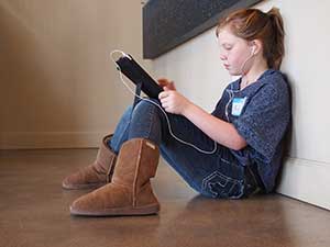 Girl playing an online educational game on her ipad