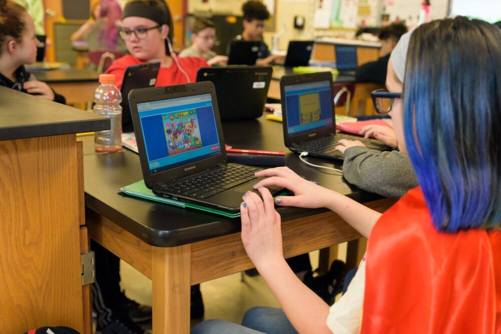 kids on laptops playing on legends of learning