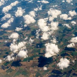 clouds floating over a field