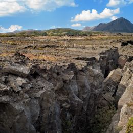 Cliff with mountains in the background