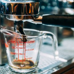 coffee being poured into a measuring cup