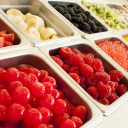 different fruits in metal containers that you would find at an ice cream shop