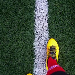 person standing on a white line on a football field