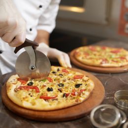 Chef cutting a pizza