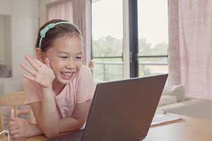 Girl socializing with her classmates during remote learning